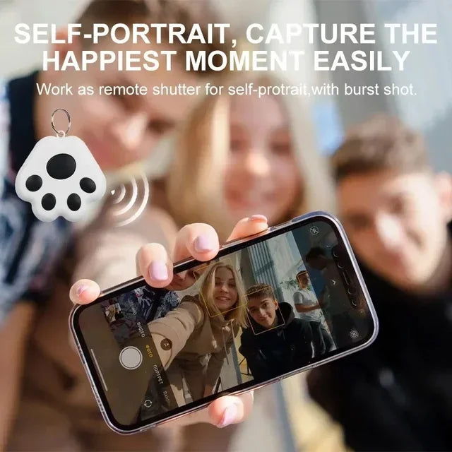 Group using GPS tracker as a remote shutter for smartphone selfies, featuring black paw-shaped device


